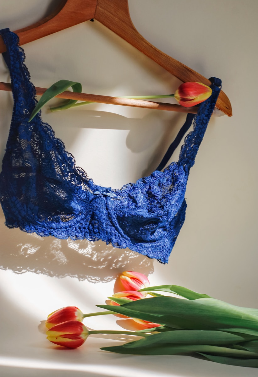 blue lace brassiere on white table